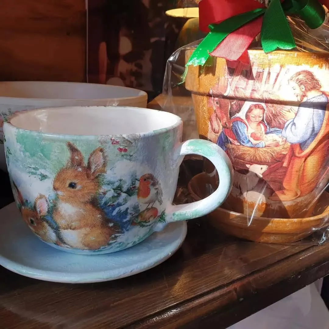 Hand-decorated ceramic cups and saucers made in the cafe